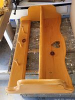 Top view of vintage solid pine shelf showing scalloped edge and heart cutout