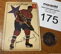 Front view of 1954-55 Parkhurst hockey card #7 featuring Maurice Rocket Richard. Shows player image, card number, and signature print. Visible wear and pen marks at the top.