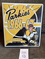 Cover of 1966-67 Parkies collector's binder with bold yellow and black graphic design and hockey player illustration.