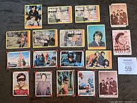 All 18 cards laid out showing front sides with scenes and portraits from Batman and The Monkees.