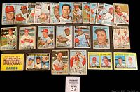 Front view of 26 assorted 1967 Topps St. Louis Cardinals baseball cards laid out in rows showing player portraits and team cards.