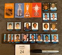 Full set of 25 hockey credit cards laid out including player photos and trophy images