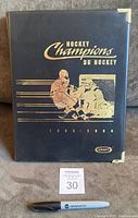 Front of black presentation binder with gold foil Hockey Champions du Hockey 1993-1994 graphics and Kraft logo.