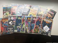 Full lot of 15 Batman comics laid out side by side, all in protective bags with backing boards.
