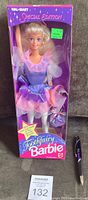 Front view of unopened boxed Barbie doll in pastel fairy costume, showing box and doll clearly under plastic window.