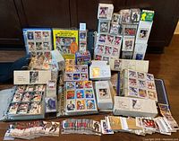 Overall display of binders, stacks of cards, boxes, and loose cards arranged on table