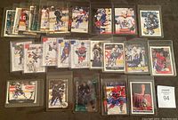 Overview photo showing all 25 autographed NHL cards laid out in rows in plastic sleeves.