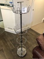 Full view of the standing chrome shoe rack showing all four carousel tiers and height.