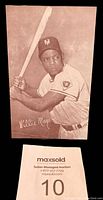 Front of a sepia tone baseball exhibit card featuring Willie Mays in batting stance with his signature printed.