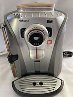Front view of espresso machine showing drip tray and steam wand