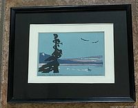 Framed watercolour painting showing sparse silhouette tree, seascape with boat, distant mountains, framed with black frame and white matting