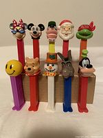 Front view of 10 vintage Pez dispensers including classic cartoon characters and holiday themes.