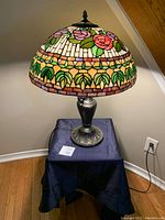 Front view of lamp on cloth-covered table showing overall appearance