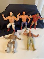 Five WWF collectible wrestling action figures displayed, showing overall presence and condition.