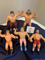 Front group shot of all five rubber wrestling figures on black cloth