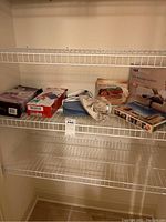Several heat and cold therapy items including bags, pads, and a massager on a wire shelf.