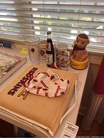 Photo showing cups, cushion, face mask, and collectible items with Redskins branding