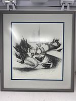 Full view of the framed black and white print featuring child’s feet and adult hands, title 'With Dad’s Help'.