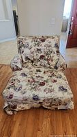 Front view of floral upholstered chaise lounge with thick seat and back cushions.