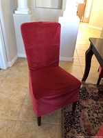 Front view of a dining chair covered in red velvet fabric with zip closure, upholstered underneath in tan twill fabric.