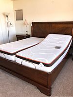 Full view of sleigh bed frame with two mattresses