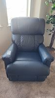 Front view of dark leather La-Z-Boy recliner chair showing padded seat, armrests and backrest.