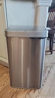 Front view of the stainless steel rectangular trash bin showing its smooth brushed finish and overall clean appearance.
