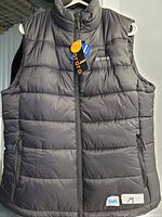 Front view of black, men's medium Ororo electrically heated padded vest with zip front and zip pockets, tag attached.