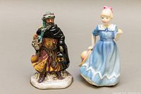 Front view of both Royal Doulton figurines showing detailed front decoration and size.