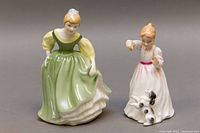Front and slight side view of Fair Maiden and Reward figurines, showing detailed painted features and postures
