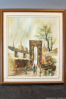 Framed oil painting depicting a street scene with an archway, buildings, and figures, signed by Oliver in the lower left corner.