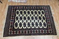 Full view of the wool rug showing the pattern, size, and condition.