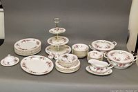 Full view of set showing plated stacks, bowls, serving pieces, three-tier tray