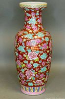Front view of the tall Asian hand painted floor vase showing detailed floral pattern on reddish-brown background.