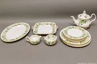 Full display of all dishes including platter, cake plate, sugar bowl, creamer, dinner and luncheon plates, and teapot