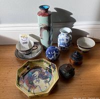 Photo showing all seven ceramic items including vases, teacup with saucer, octagonal plate and lidded pots