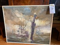 Full view of signed original oil painting of boats on water with cloudy sky.