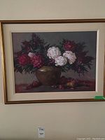 Full view of framed floral still life painting with flowers in vase and fruit on table.
