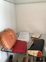 Top shelf showing all five evening bags in a display with visible details of each item.