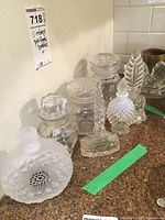Multiple glass perfume bottles arranged on kitchen countertop