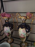 Front view showing both vases side by side on shelf