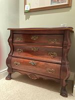 Front view of miniature walnut cabinet showing three faux drawer fronts and brass-tone hardware.