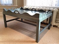 Angled view of the pale blue coffee table showing tray top, legs, and overall design.