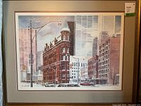 Framed watercolor print showing Toronto Flatiron Building in urban setting with signature and edition number visible at lower left.