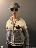 Mannequin wearing the hooded Canada cardigan sweater and the vintage grey wool hat with rhinestones, front view with zipped sweater