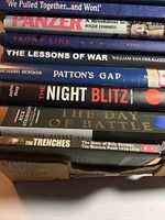 Stack of books showing titles including 'We Pulled Together...and Won!', 'Panzer', 'Front Line', 'The Lessons of War', 'Patton's Gap', 'The Night Blitz', 'The Day of Battle', 'The Trenches'. Photos emphasize condition and title readability.