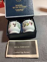 Closed Royal Worcester box showing brand and series on lid, containing two porcelain egg coddlers with blackberry design.