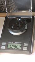 Smokey quartz cushion cut gemstone on digital scale showing 30.000 grams weight.