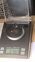 Photo of the sapphire gemstone on a digital scale showing weight 0.78 carats.
