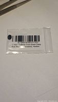Photo of sapphire inside a sealed plastic bag with gem certification label showing details